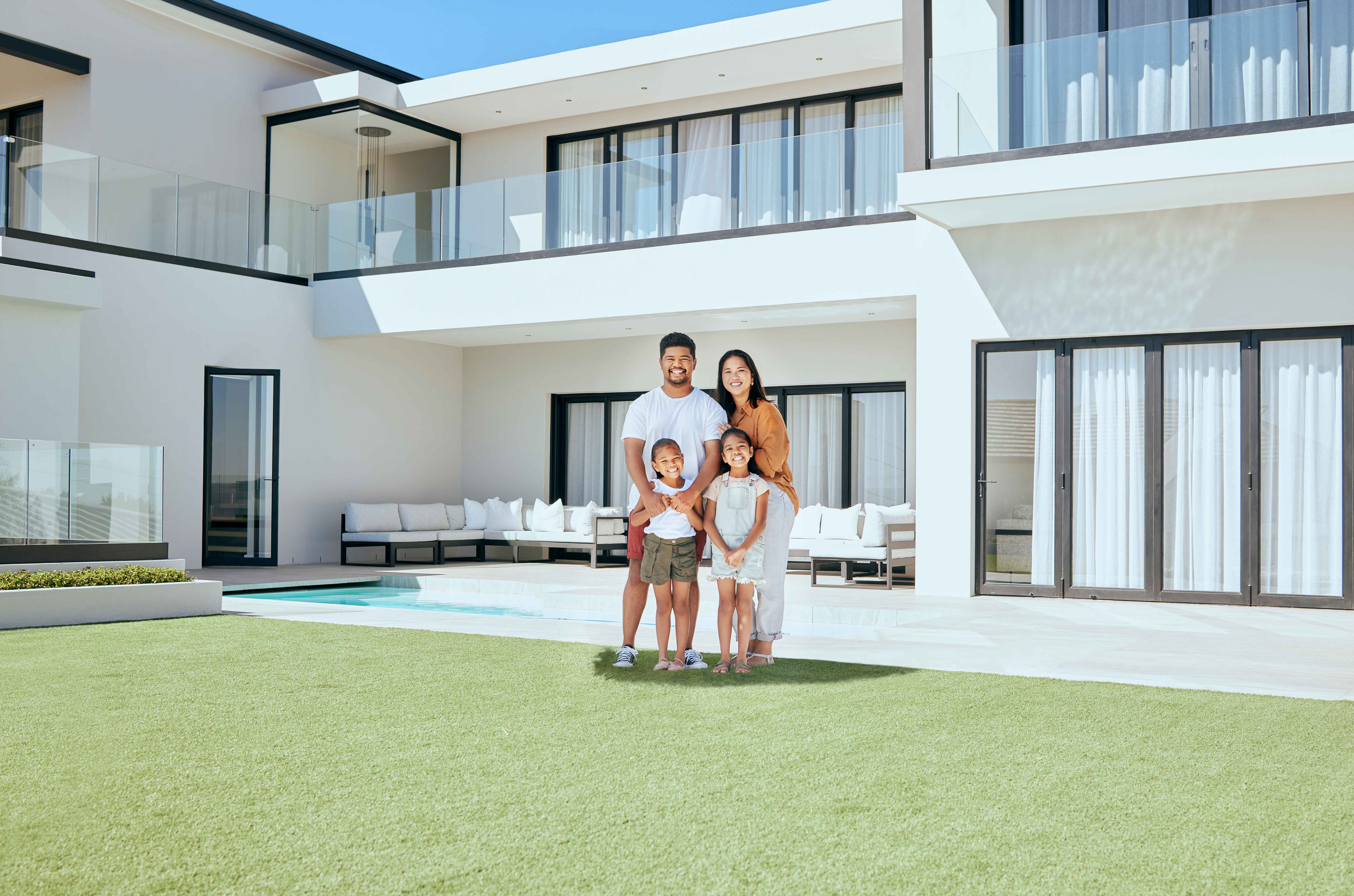 Smiling family standing together outside a modern luxury villa in Dubai, symbolizing property ownership and the transformational journey with Exclusive Luxe Tours.