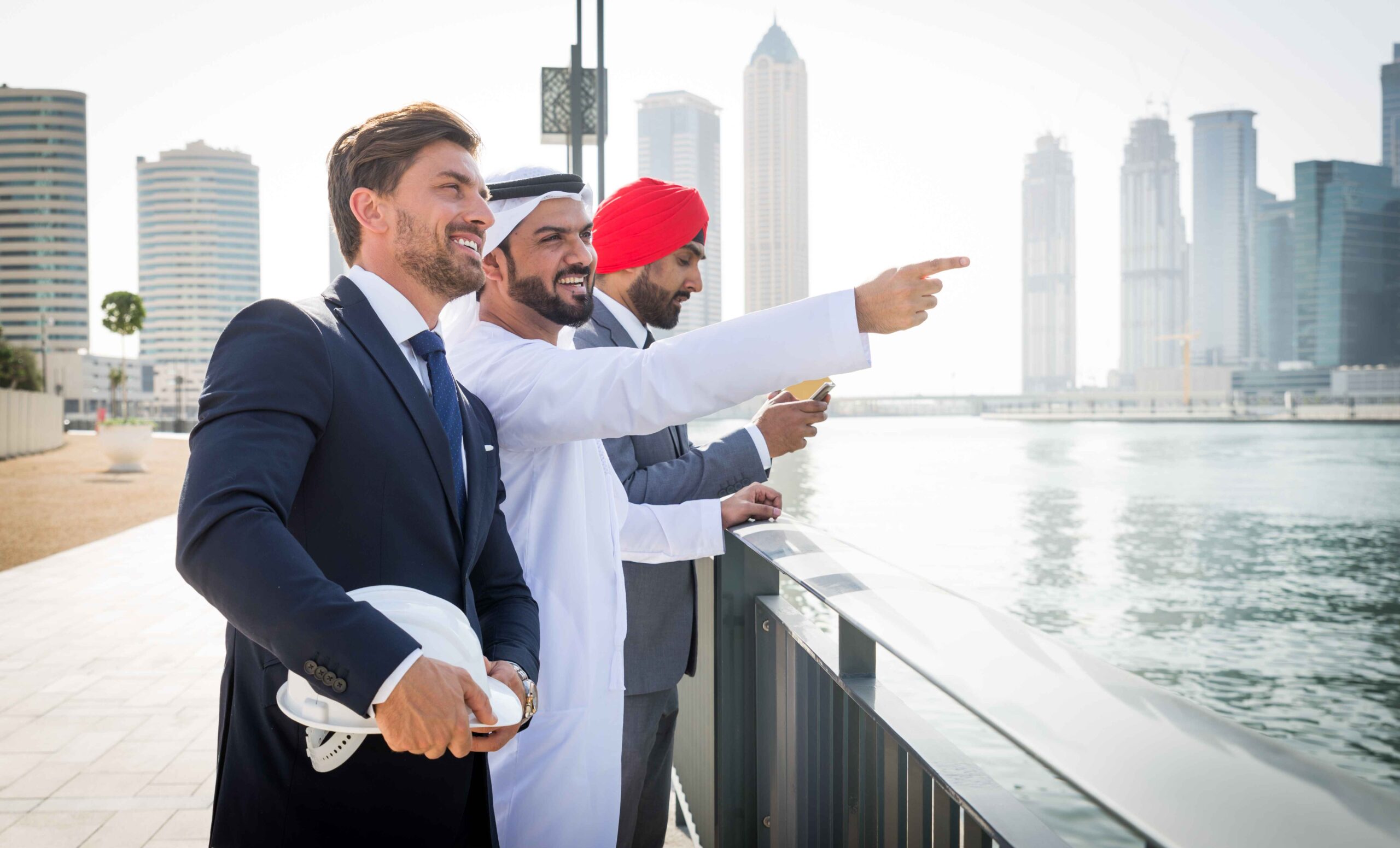 Global investors and advisors overlooking Dubai’s modern skyline during a private bespoke real estate tour, discussing landmark developments and future ownership opportunities.